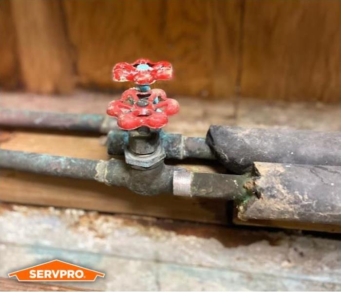 Broken pipe with red knob and SERVPRO logo